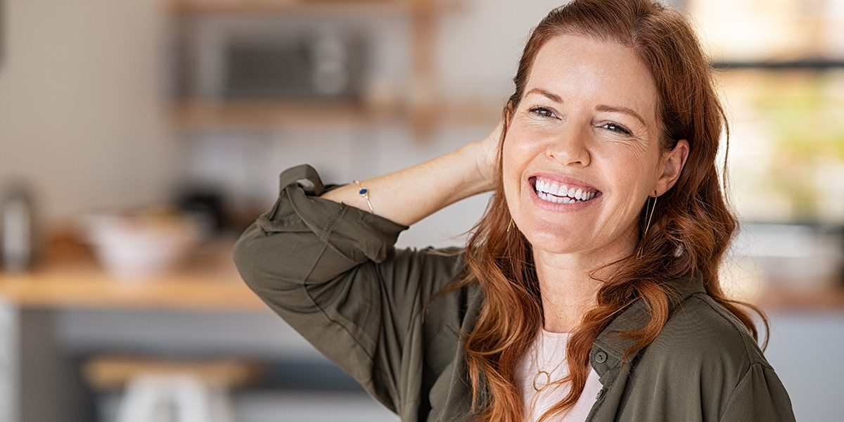 smiling woman representing hormone balance, wellness, and healthy lifestyle
