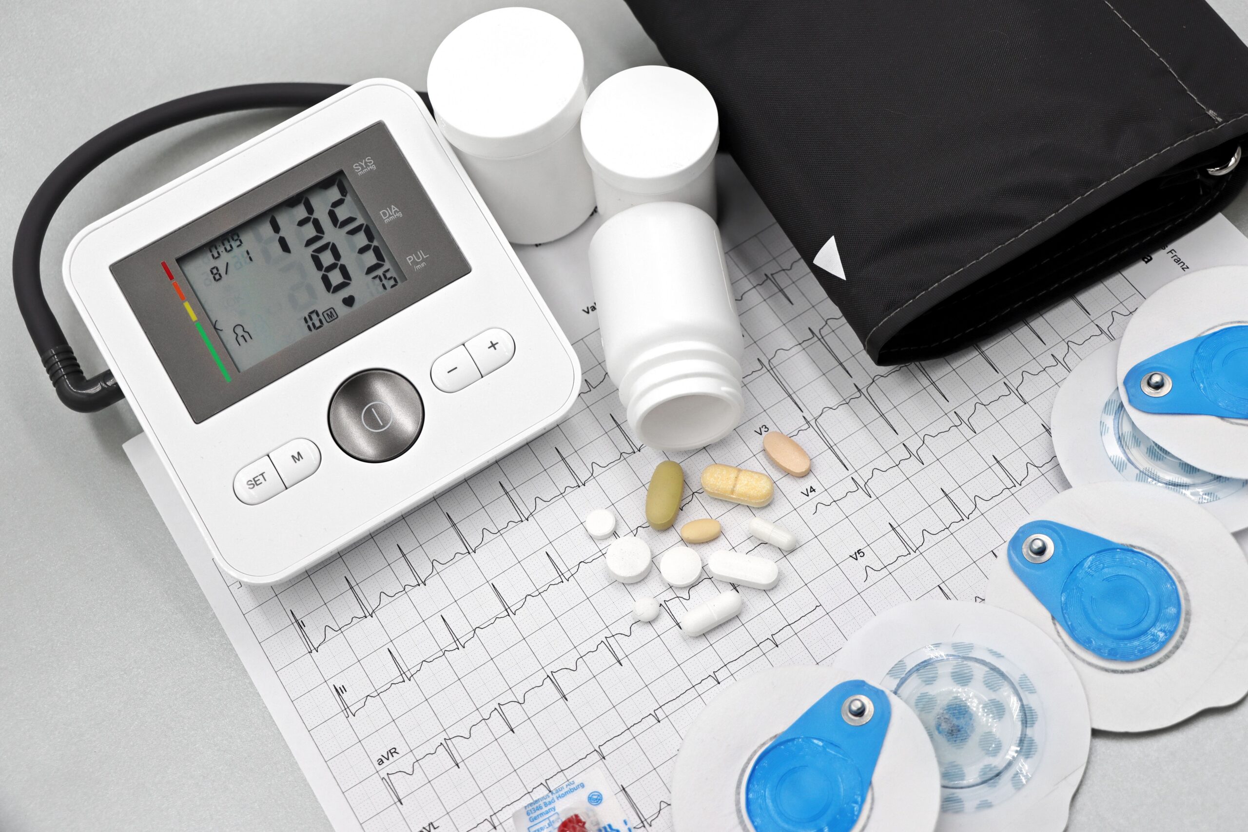 TRT cardiovascular risk monitoring: blood pressure monitor, ECG printout, electrodes, and medications
