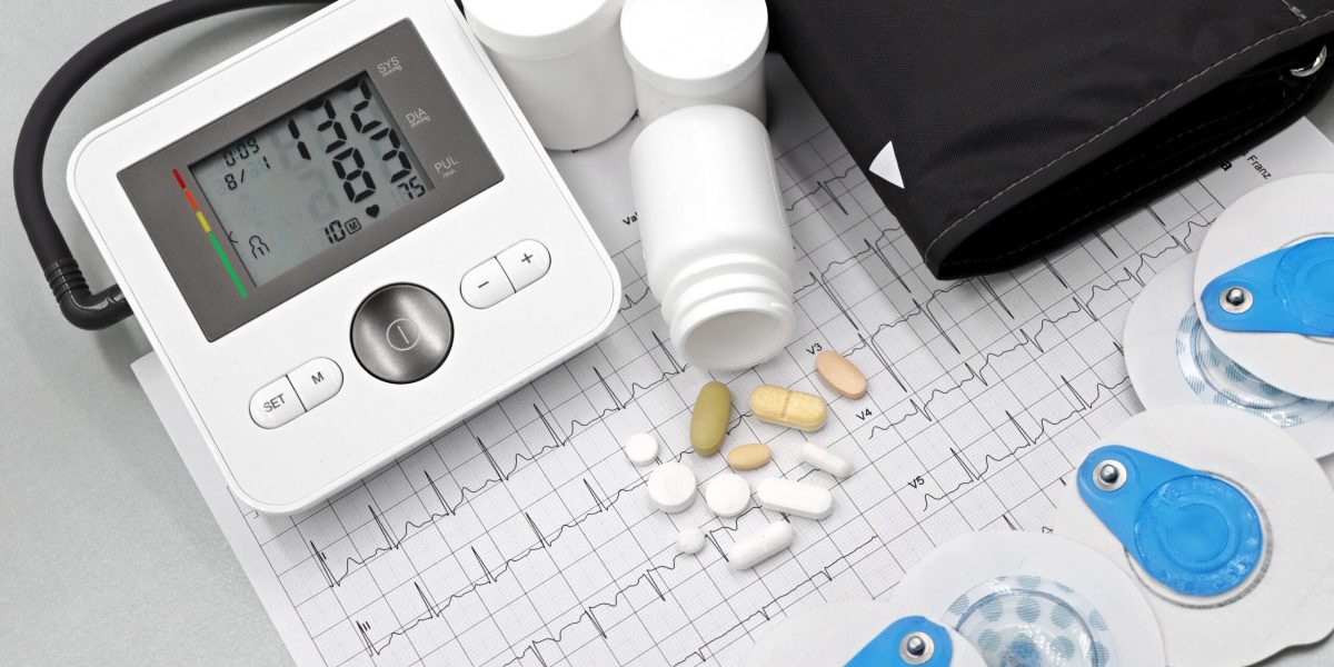TRT cardiovascular risk monitoring: blood pressure monitor, ECG printout, electrodes, and medications